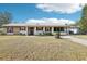 Charming single-story home with a well-maintained lawn, metal roof, and colorful accents at 2314 Falkner Rd, Orlando, FL 32810
