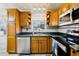Efficient kitchen layout with modern appliances, solid wood cabinets, and a double sink under a window at 2314 Falkner Rd, Orlando, FL 32810