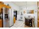 Well-lit kitchen showcasing stainless steel refrigerator and a seamless transition to the dining space at 2314 Falkner Rd, Orlando, FL 32810