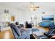 Bright and airy living room featuring hardwood floors, ceiling fan, and access to the dining area at 2314 Falkner Rd, Orlando, FL 32810