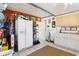 Spacious utility room with storage, white appliances and cabinets, ideal for organization at 2314 Falkner Rd, Orlando, FL 32810