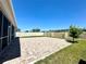 A brick patio backyard is perfect for entertaining with an extended screened porch and green space at 2648 Needlepoint St, Kissimmee, FL 34741