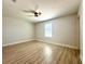 Bedroom features natural light, wood floors, and a ceiling fan at 2648 Needlepoint St, Kissimmee, FL 34741