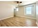 Bedroom features natural light, wood floors, and a ceiling fan at 2648 Needlepoint St, Kissimmee, FL 34741