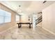 Spacious dining room with marble floors, modern chandeliers, and windows with natural light for inviting gatherings at 2648 Needlepoint St, Kissimmee, FL 34741
