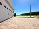 A brick driveway leads to the garage of this house that is located on a corner lot and near a lake at 2648 Needlepoint St, Kissimmee, FL 34741