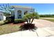 Well-maintained front yard features lush landscaping, a brick driveway, and manicured shrubs, providing great curb appeal at 2648 Needlepoint St, Kissimmee, FL 34741