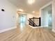 Hallway features wood floors and a wooden staircase at 2648 Needlepoint St, Kissimmee, FL 34741