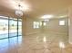 Expansive living room with marble floors, sliding glass doors, recessed lighting, and chandelier at 2648 Needlepoint St, Kissimmee, FL 34741