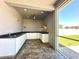 This outdoor kitchen features white cabinets, dark countertops, and modern appliances, perfect for entertaining at 2648 Needlepoint St, Kissimmee, FL 34741