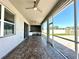 A spacious screened porch features ceiling fans and leads to an outdoor kitchen and brick paved patio at 2648 Needlepoint St, Kissimmee, FL 34741