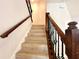 Staircase with wood railings and decorative iron balusters at 2648 Needlepoint St, Kissimmee, FL 34741