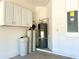 A Utility Room with modern equipment, shelving, and cabinetry. Perfect for laundry, utilities, and additional storage at 2648 Needlepoint St, Kissimmee, FL 34741