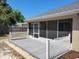 This is a backyard featuring a screened patio and a wooden fence at 266 Paradise Woods Ct, Davenport, FL 33896
