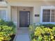 Inviting front entrance with tiled walkway, manicured bushes, and address plaque near the door at 266 Paradise Woods Ct, Davenport, FL 33896