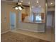 Open living room area featuring tile flooring, with view to the kitchen and breakfast bar at 266 Paradise Woods Ct, Davenport, FL 33896