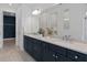 Modern bathroom features double sinks with granite countertops and a walk-in shower at 2725 Serenity Meadow Dr, Kissimmee, FL 34744