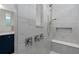 Elegant bathroom with a marble tiled shower, convenient bench, and sleek fixtures at 2725 Serenity Meadow Dr, Kissimmee, FL 34744