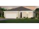Charming single-story home featuring a two-car garage, neutral palette, and beautifully landscaped front yard at 2725 Serenity Meadow Dr, Kissimmee, FL 34744