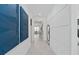 Bright hallway with modern accent wall and tile flooring, leading to the main living areas at 2725 Serenity Meadow Dr, Kissimmee, FL 34744
