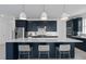 Well-appointed kitchen featuring a large island, pendant lighting, and sleek dark blue cabinetry at 2725 Serenity Meadow Dr, Kissimmee, FL 34744