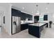 Stylish kitchen with dark blue cabinets, a central island with seating, and stainless steel appliances at 2725 Serenity Meadow Dr, Kissimmee, FL 34744