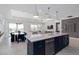 Open concept living room, dining, and kitchen area with an island, modern decor, and plenty of natural light at 2725 Serenity Meadow Dr, Kissimmee, FL 34744