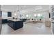 Open-concept living room and kitchen featuring an island, modern lighting, and seamless flow to the outdoors at 2725 Serenity Meadow Dr, Kissimmee, FL 34744