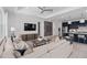 Open-concept living room featuring modern decor, a ceiling fan, and seamless flow into the kitchen area at 2725 Serenity Meadow Dr, Kissimmee, FL 34744