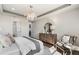 Modern main bedroom features tray ceiling, chandelier, and stylish decor with wood flooring at 2737 Serenity Meadow Dr, Kissimmee, FL 34744