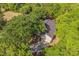 An aerial view showcases the beautiful home nestled among mature trees, offering both privacy and natural beauty at 2765 Eldred Ct, Apopka, FL 32712