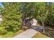 A home with a long driveway surrounded by lush greenery and mature trees at 2765 Eldred Ct, Apopka, FL 32712