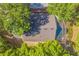 An aerial shot exhibits the home's roof and screened pool, set amidst lush greenery for ultimate privacy at 2765 Eldred Ct, Apopka, FL 32712