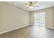 Bedroom overlooking pool featuring wood-look floors and neutral paint at 2765 Eldred Ct, Apopka, FL 32712