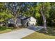 Side view of a single-story home with an attached two-car garage and large driveway at 2765 Eldred Ct, Apopka, FL 32712