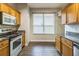 Bright kitchen featuring stainless steel appliances, wood cabinets, and tile backsplash at 2765 Eldred Ct, Apopka, FL 32712