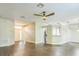 Well-lit living room with wood-look floors open to the entry and kitchen at 2765 Eldred Ct, Apopka, FL 32712