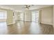 Open-concept living room with wood-look flooring and sliding glass doors to the lanai at 2765 Eldred Ct, Apopka, FL 32712
