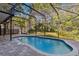 The large screened-in pool boasts a brick patio and lush backyard, offering the perfect setting for relaxation and fun at 2765 Eldred Ct, Apopka, FL 32712