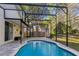 Inviting screened pool with brick surround and a serene backyard view, perfect for relaxation and outdoor entertainment at 2765 Eldred Ct, Apopka, FL 32712