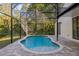 Relaxing screened pool featuring a brick surround and calming backyard view provides a private oasis for leisure at 2765 Eldred Ct, Apopka, FL 32712