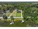 An aerial view showcasing the home, nestled amidst lush greenery and featuring water access at 2825 Lakeshore Dr, Mount Dora, FL 32757