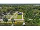 Aerial view of the property and surrounding area, including the lake and dock at 2825 Lakeshore Dr, Mount Dora, FL 32757