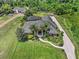 An aerial view showcases a meticulously landscaped property with a large home, pool, and lush greenery at 2825 Lakeshore Dr, Mount Dora, FL 32757