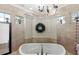 Elegant bathroom featuring a soaking tub with decorative fixtures and beautiful tile surround, creating a spa-like retreat at 2825 Lakeshore Dr, Mount Dora, FL 32757