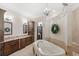 Luxurious bathroom with dual vanities, soaking tub, and elegant finishes at 2825 Lakeshore Dr, Mount Dora, FL 32757