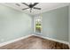 A spacious and bright bedroom with one window and wood-style flooring, ready for personalization and comfort at 2825 Lakeshore Dr, Mount Dora, FL 32757