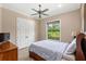 Comfortable bedroom featuring a queen-size bed, wooden floors, a window and closet with an airy atmosphere at 2825 Lakeshore Dr, Mount Dora, FL 32757