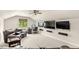 Bonus room features a comfortable seating area, a desk, and a media wall at 2825 Lakeshore Dr, Mount Dora, FL 32757