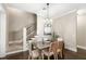 Elegant dining room adjacent to the stairs featuring a decorative chandelier at 2825 Lakeshore Dr, Mount Dora, FL 32757